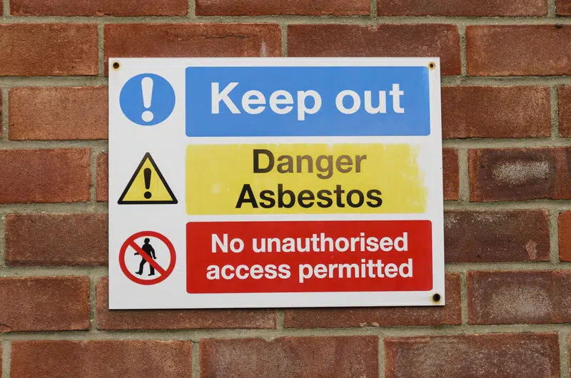 Sign warning to keep out because of danger presented by asbestos