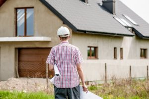 general contractor standing outside house being remodeled