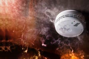 Smoke Detector And Fire Alarm In Action Background. What To Do After A Fire