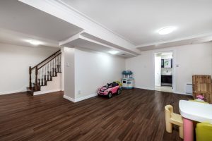 Newly finished basement with hardwood floors and kids toys
